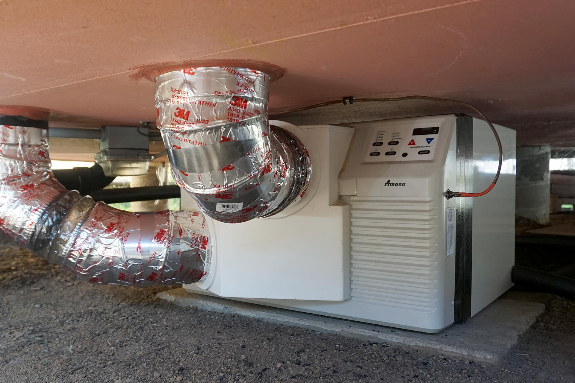 A custom, modified PTAC unit that is installed outside and ducted to the inside. An exterior, ducted heat pump unit.