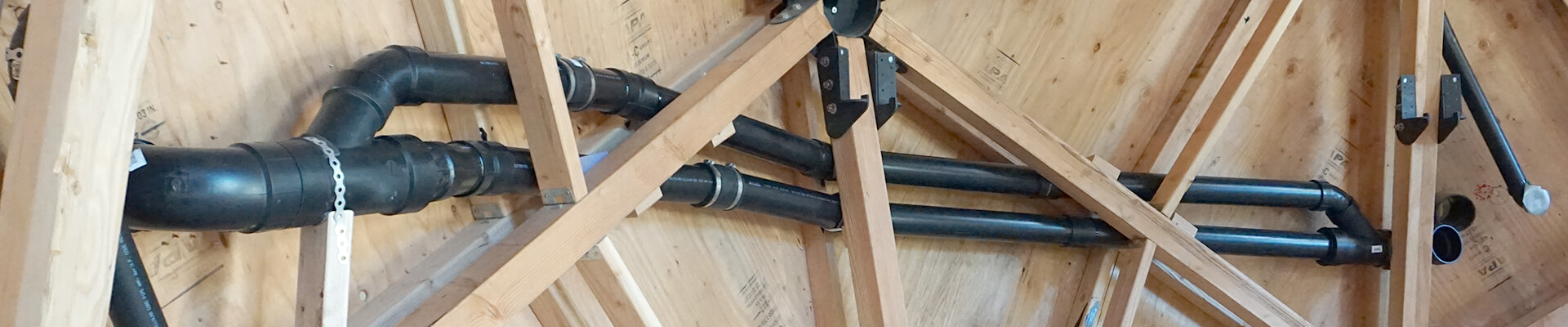 A close-up view of the pipes, ducting, and custom loft brackets in the walls of the Mini Dome.